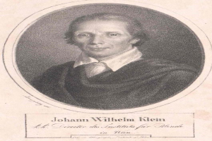 Schwarzes und weißes Porträt von Johann Wilhelm Klein, Direktor des Instituts für Blinde in Wien, der einen weißen Hemd und einen ernsten Gesichtsausdruck trägt, mit deutschem Text unten.